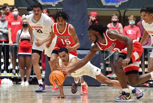 Milton's Bruce Thornton (2) challenges Berkmar's Destin Logan (4) on a loose ball during the Class 7A boys championship game Saturday, March 13, 2021, at the Macon Centreplex in Macon. Milton won 52-47. (Hyosub Shin / Hyosub.Shin@ajc.com)