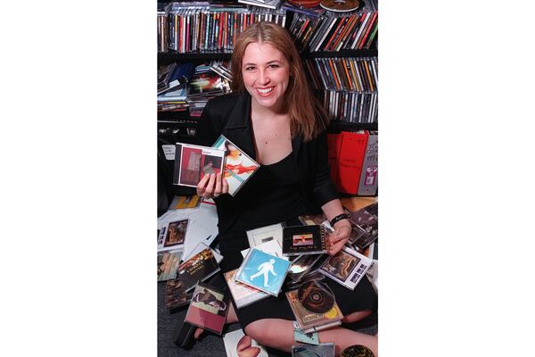 Lucy Lawler-Freas in 2000 while working for Concert/Southern in an office at the then-Roxy Theatre in Buckhead surrounded hundreds of CDs from bands' submissions for Music Midtown. PHIL SKINNER