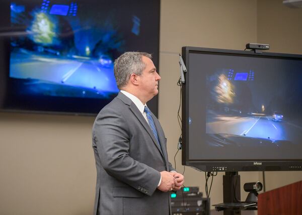 Jason Saliba, Cobb's Deputy Chief Assistant District Attorney, shows reporters video footage related to the fatal police shooting.