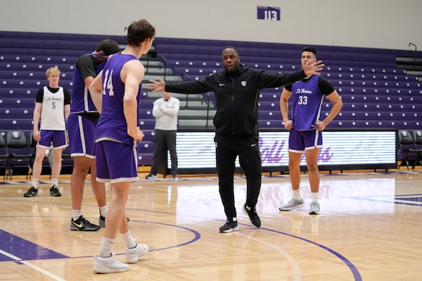 St. Thomas assistant coach Kenneth Lowe, center, gives directions during NCAA college basketball practice, Wednesday, Feb. 26, 2025, in St. Paul, Minn. (AP Photo/Abbie Parr)