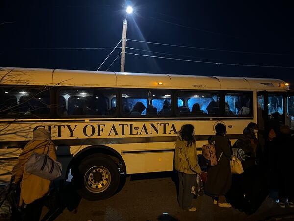 Women and children who were staying in a crowded city of Atlanta warming center at Central Park lined up to take a city bus to an overflow warming center opened nearby on January 16, 2024. The frigid temperatures led more people to seek a way out of the cold. Matt Kempner / AJC