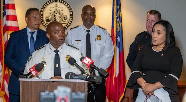 Atlanta Police Chief Rodney Bryant speaks at a press conference called by Fulton County District Attorney Fani Willis (right) about gang indictments, in Atlanta on Tuesday, May 10, 2022.   Fulton County Sheriff Patrick Labat (left) also spoke. (Steve Schaefer / steve.schaefer@ajc.com)