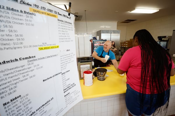 Tidwell Carter, owner of Carter’s Fried Chicken, serves a customer at his restaurant in Douglas, Ga. After Hurricane Helene, Carter said the restaurant had to replace its roof, repair sheet rock and more. But since then, he said business had actually improved. (Miguel Martinez/AJC)