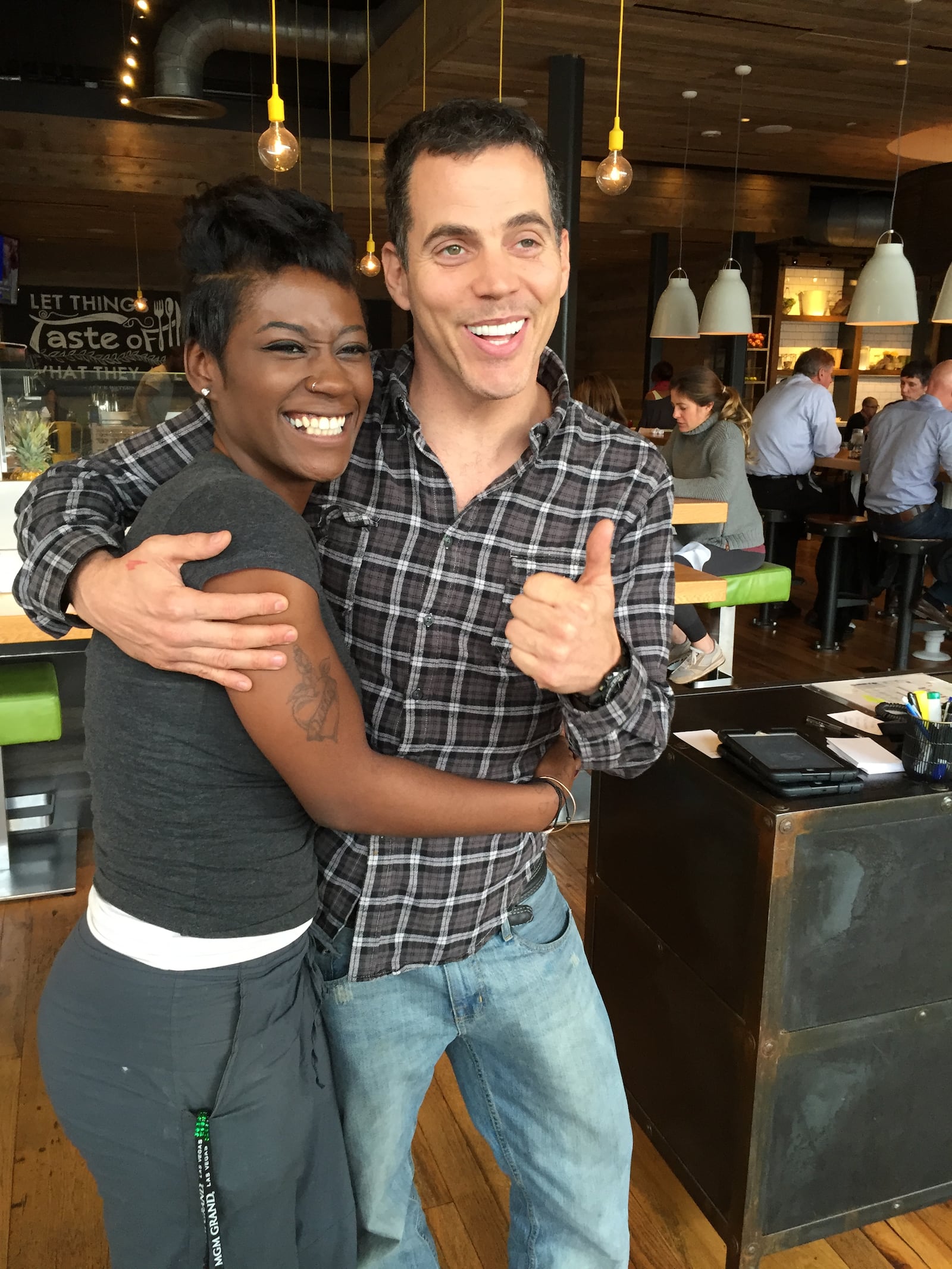 Bria Carter, a greeter at True Food Kitchen and huge fan of Steve O, gets her picture taken. She said she was thrilled he was still alive and kicking. She noticed he was sitting at the bar with his butt crack showing so she did a little cartoon rendition for him on a piece of paper and handed it to him. "That crack is so classic Steve O," she said. "He came in here and said he loved my haircut. He's so nice. I've always been a fan!" CREDIT: Rodney Ho/ rho@ajc.com