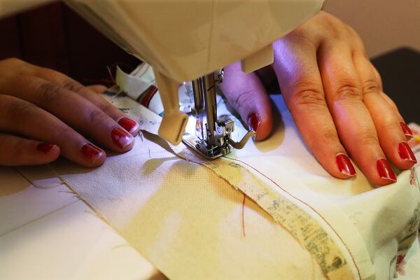 An Afghan refugee learns how to sew in the training room at Peace of Thread on Thursday, Aug. 4, 2022, in Clarkston. Curtis Compton / Curtis Compton@ajc.com