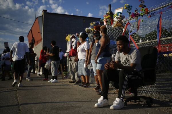 People gather outside the restaurant owned by David McAtee in Louisville, Ky., on June 2, 2020. McAtee was shot and killed by law enforcement officers enforcing a curfew imposed during protests sparked by the death of George Floyd, an African American man, in Minneapolis police custody. 