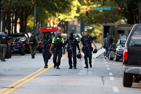 Atlanta officers leave the scene on 14th Street after Tuesday's standoff.