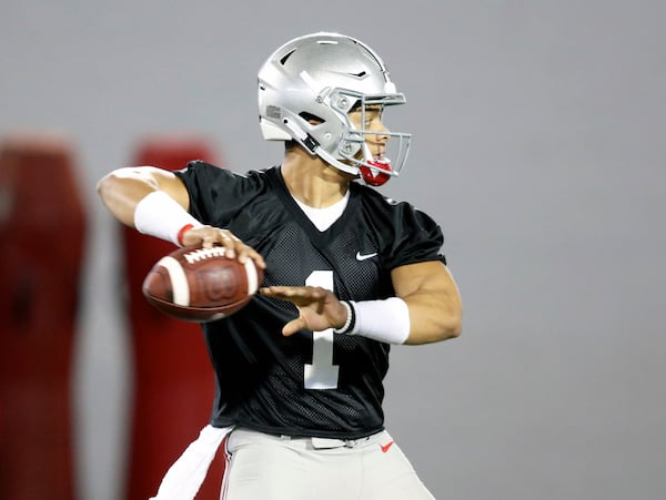 Ohio State quarterback Justin Fields drops back to pass during practice in Columbus, Ohio, Wednesday, March 6, 2019. (AP Photo/Paul Vernon)