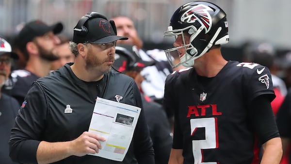 Falcons head coach Arthur Smith and quarterback Matt Ryan confer in the final minutes against the Washington Football Team Sunday, Oct. 3, 2021, at Mercedes-Benz Stadium in Atlanta. (Curtis Compton / Curtis.Compton@ajc.com)