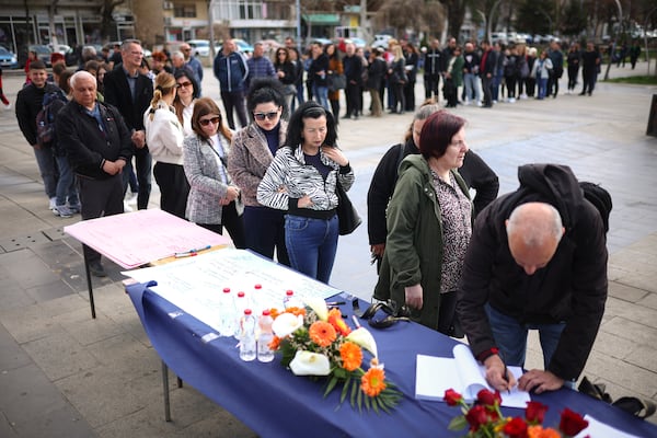 People wait in line to write condolence messages for the victims of a massive nightclub fire in the town of Kocani, North Macedonia, Monday, March 17, 2025, (AP Photo/Armin Durgut)