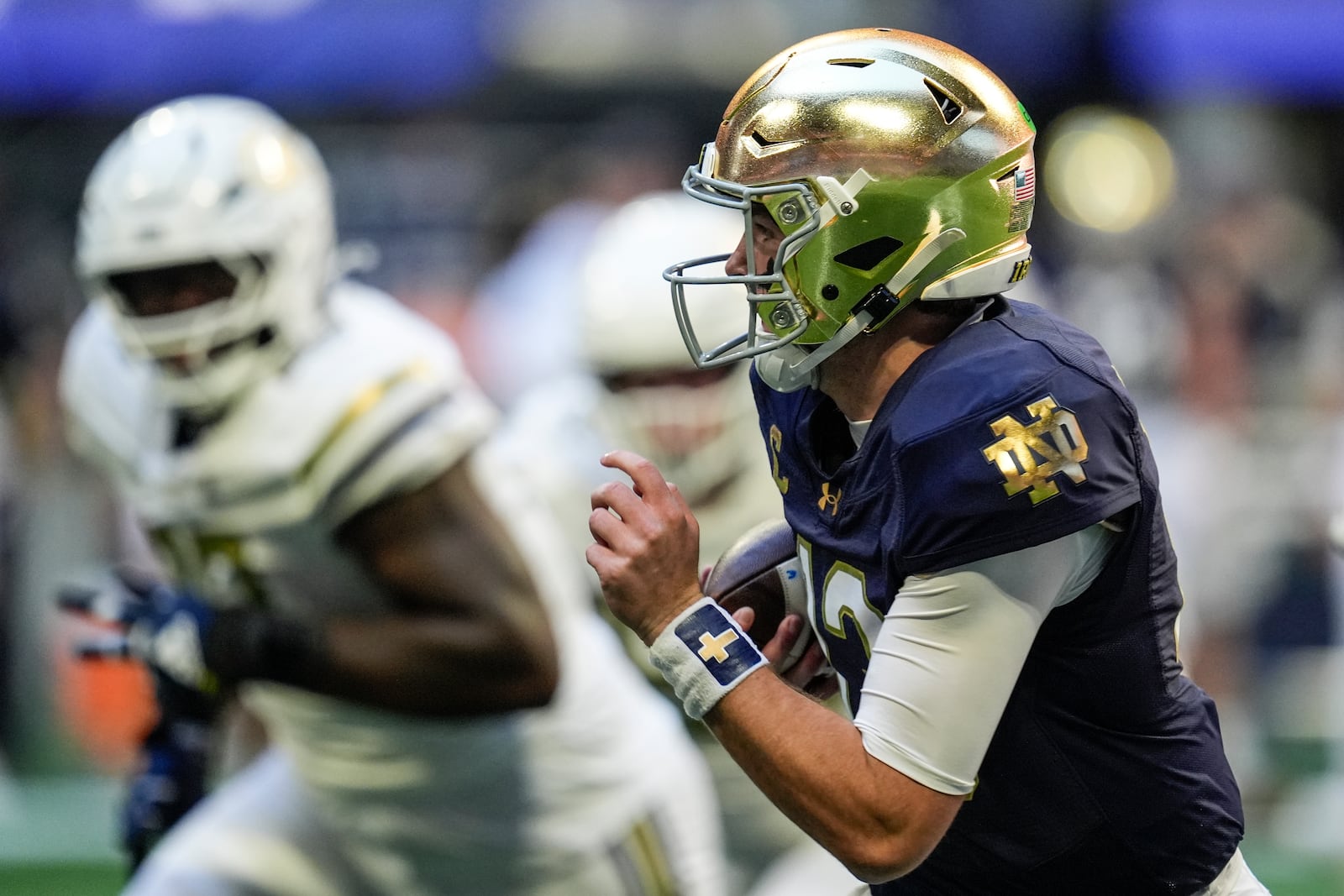 Notre Dame quarterback Riley Leonard (13) runs out of the pocket against Georgia Tech during the first half of an NCAA college football game, Saturday, Oct. 19, 2024, in Atlanta. (AP Photo/Mike Stewart)