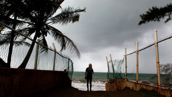 A woman looks at heavy surf as Hurricane Irma approaches Puerto Rico in Luquillo, on September 6, 2017.
Irma is expected to reach the Virgin Islands and Puerto Rico by nightfall on September 6.