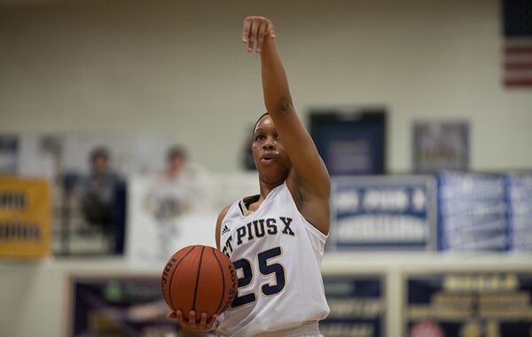 February 21, 2014 Atlanta- St. Pius player Asia Durr (25) signals before taking a shot from the free-throw line during a High School basketball game on Friday, Feb. 21, 2014, in Atlanta, Ga. St. Pius defeated North Oconee 52-49 in the first round of the high school state tournament. BRANDEN CAMP/SPECIAL St. Pius' Asia Durr follows through her shot before taking a free-throw from the foul line. (Branden Camp / Special to AJC)