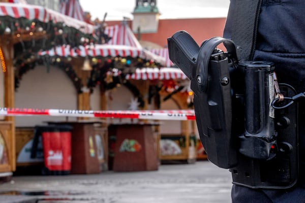 A police officer guards the Christmas Market, where a car drove into a crowd on Friday evening, in Magdeburg, Germany, Sunday morning , Dec. 22, 2024. (AP Photo/Michael Probst)