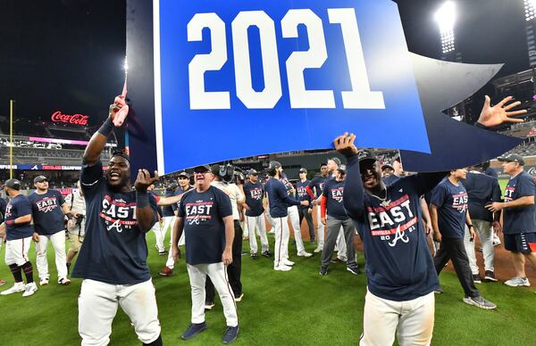 Atlanta Braves players celebrate their latest division title clinched after Thursday's 5-3 victory over the Phillies at Truist Park. (Hyosub Shin/hshin@ajc.com)