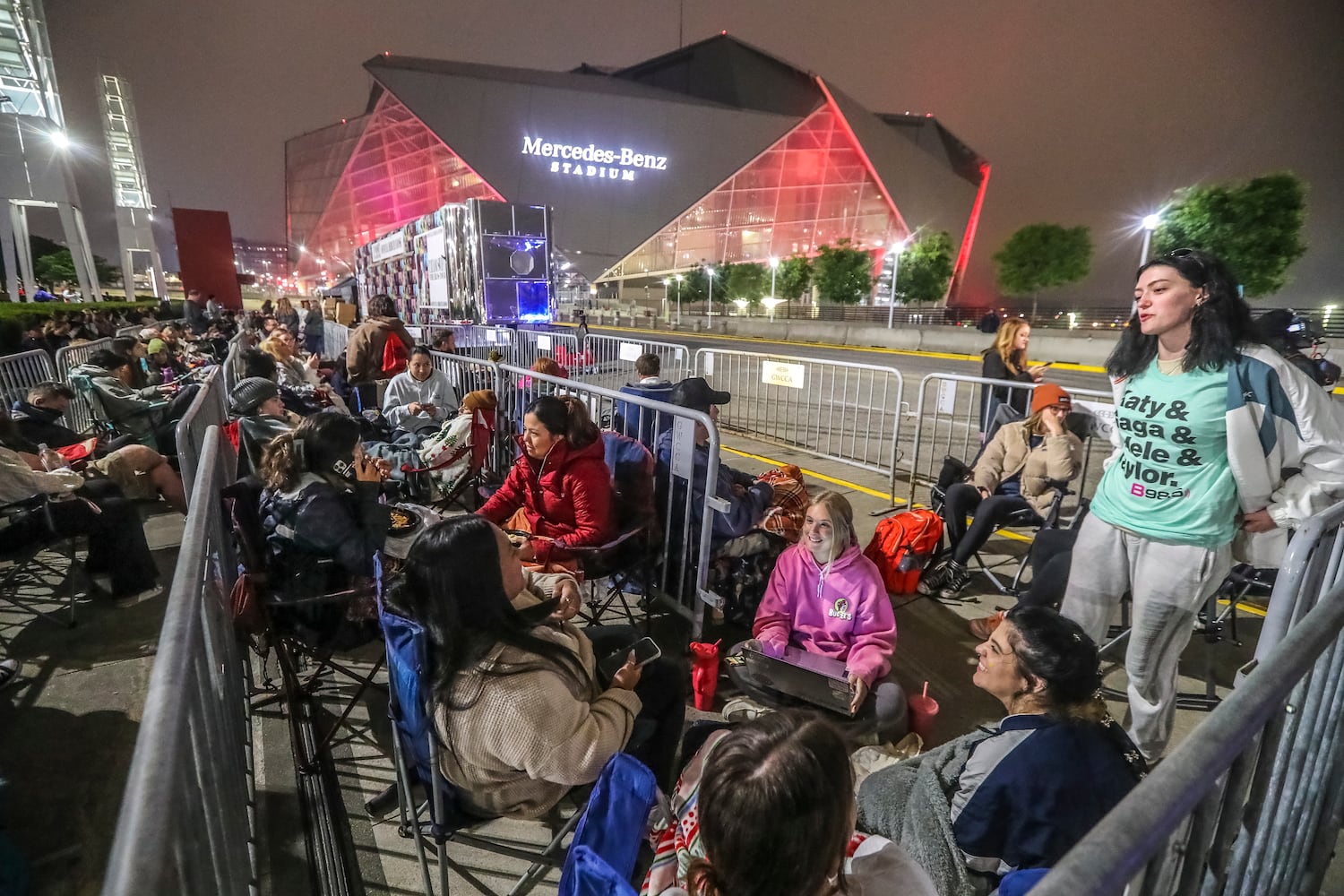 Taylor Swift fans braved cooler morning temperatures and drizzle while they waited in line before daybreak at the Georgia World Congress Center International Plaza outside Mercedes-Benz Stadium to buy official Swift merchandise on Thursday, April 27, 2023. Merchandise for Swift’s Eras Tour, which kicks off Friday for a three-night stop at the Benz, went on sale at the International Plaza outside the stadium Thursday. (John Spink / John.Spink@ajc.com)