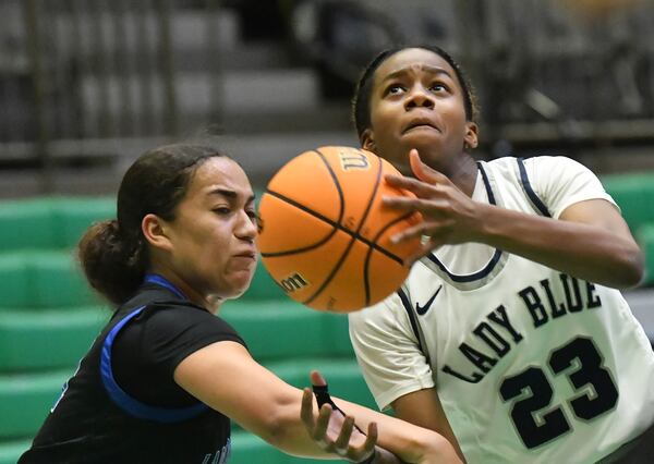 Norcross' Jania Akins tries to shoot as Campbell's Laila Battle blocks the ball in the first half of the 2022 GHSA Basketball Playoffs at Buford Arena on Friday. (Hyosub Shin / Hyosub.Shin@ajc.com)