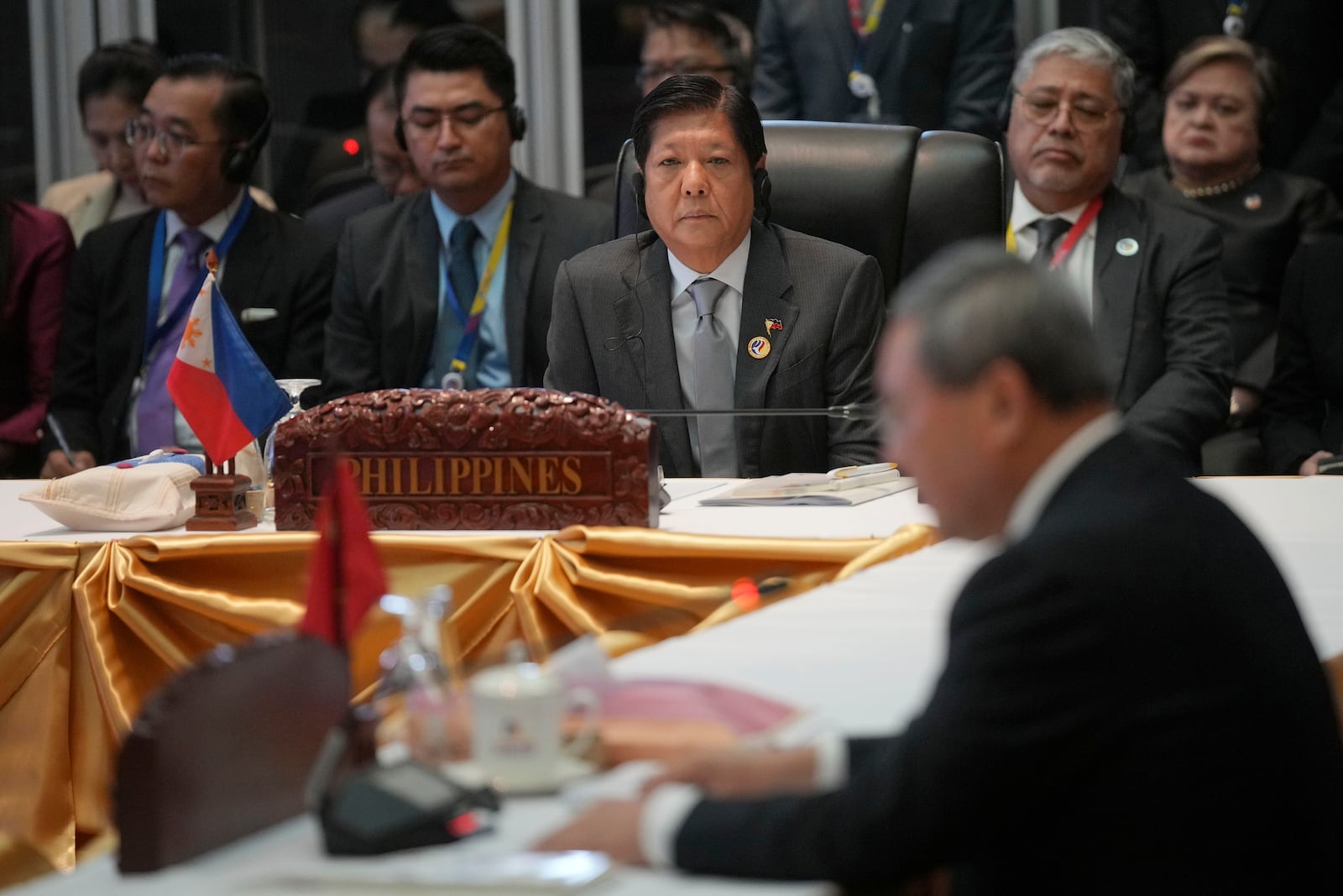 Philippine's President Ferdinand Marcos Jr., center in the background, listens as Chinese Premier Li Qiang, bottom right, delivers his opening remarks during the 27th Association of Southeast Asian Nations (ASEAN)-China Summit in Vientiane, Laos, Thursday, Oct. 10, 2024. (AP Photo/Dita Alangkara)