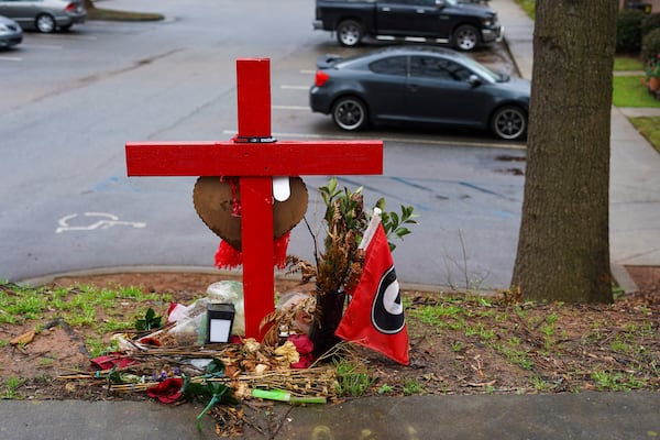 A memorial honoring the site of the car crash that ended the lives of Georgia offensive lineman, Devin Willock, 20, and UGA recruiting analyst, Chandler LeCroy, 24, sits at the intersection of Barnett Shoals and Stroud roads, east of downtown Athens, Georgia, on Thursday, March 2, 2023. (Olivia Bowdoin / AJC). 
