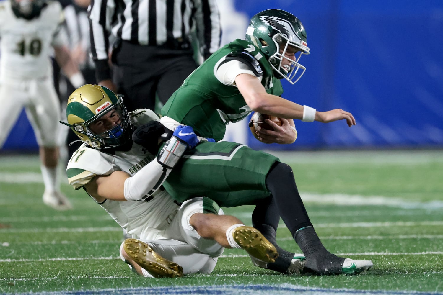 Dec. 30, 2020 - Atlanta, Ga: Collins Hill quarterback Sam Horn (21) is tackled by Grayson linebacker Sebastian Sagar (11) during the first half of their Class 7A state high school football final at Center Parc Stadium Wednesday, December 30, 2020 in Atlanta. JASON GETZ FOR THE ATLANTA JOURNAL-CONSTITUTION