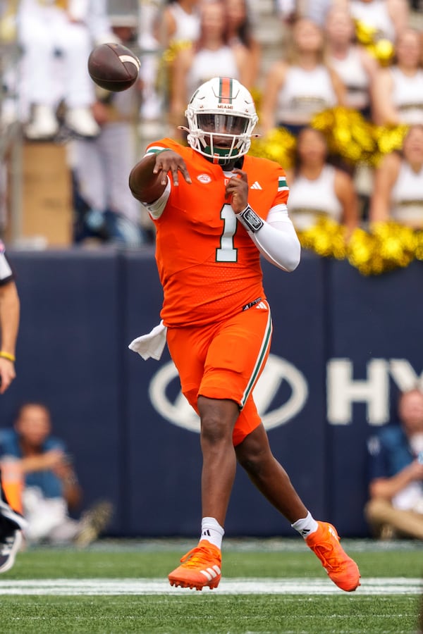 Miami quarterback Cam Ward (1) throws during the first half of an NCAA college football game against the Georgia Tech Yellowjackets, Saturday, Nov. 9, 2024, in Atlanta. (AP Photo/Jason Allen)