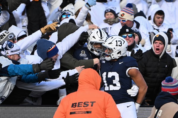 Penn State linebacker Tony Rojas celebrates an interception for a touchdown with Abdul Carter against SMU during the first half in the first round of the NCAA College Football Playoff, Saturday, Dec. 21, 2024, in State College, Pa. (AP Photo/Barry Reeger)