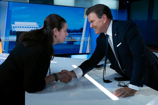 Ukraine's Ambassador to the United States Oksana Markarova shakes hands with Bret Baier after an interview with Ukraine's President Volodymyr Zelenskyy for FOX News Channel's Special Report with Bret Baier in Washington, Friday, Feb. 28, 2025. (AP Photo/Jose Luis Magana)