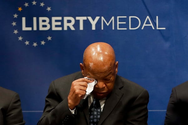 Rep. John Lewis, D-Ga., wipes his face during a ceremony where he was being presented with the Liberty Medal for his dedication to civil rights at the National Constitution Center, Monday, Sept. 19, 2016, in Philadelphia. The honor is given annually to an individual who displays courage and conviction while striving to secure liberty for people worldwide. (AP Photo/Matt Slocum)