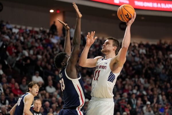 Saint Mary's center Mitchell Saxen (11) shoots over Gonzaga forward Graham Ike (13) during the first half of an NCAA college basketball championship game in the West Coast Conference men's tournament Tuesday, March 11, 2025, in Las Vegas. (AP Photo/John Locher)