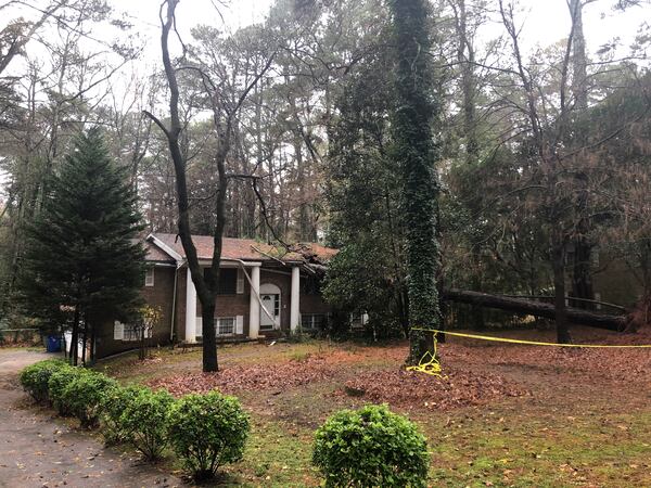 Turad and Halima Garba had to leave their home early Sunday morning after a mature pine crashed into the roof. The couple and their 1-year-old daughter are staying in a nearby hotel because a DeKalb fire crew said the structure is too unstable for habitation. (Photo: ARLINDA SMITH BROADY/AJC)