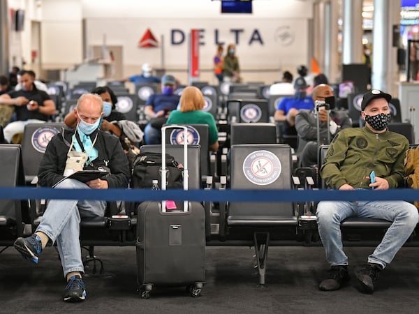 July 22, 2020 Atlanta - Social distancing signs are  displayed as Delta customers wait on Concourse A at Hartsfield-Jackson International Airport on Wednesday, July 22, 2020. (Hyosub Shin / Hyosub.Shin@ajc.com)