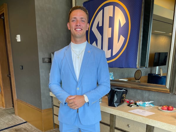 Georgia quarterback Carson Beck poses to show off the outfit he chose for SEC Football Media Days in Dallas on Tuesday, July 16, 2024. (Photo by Chip Towers/ctowers@ajc.com)