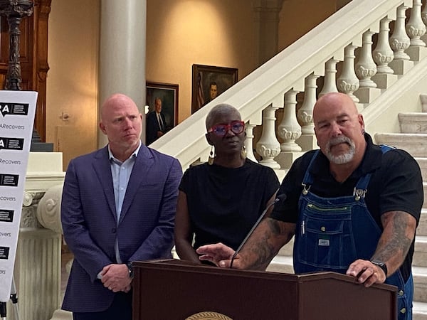 The American Addiction Recovery Association officially launched Wednesday, June 26, 2024 with a press conference and reception at the Georgia Capitol. In this photo its president, former UGA assistant football coach Scott Cochran, and board member TaTa-Nisha Frazier listen to addiction survivor Jon Langston speak at the press conference. (PHOTO by Ariel Hart / ahart@ajc.com)