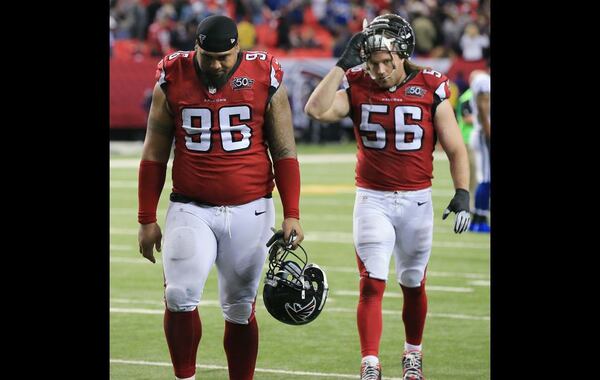 Falcons defensive tackle Paul Soliai and linebacker Brooks Reed are dejected after the 24-21 loss to the Colts. (Curtis Compton/AJC)