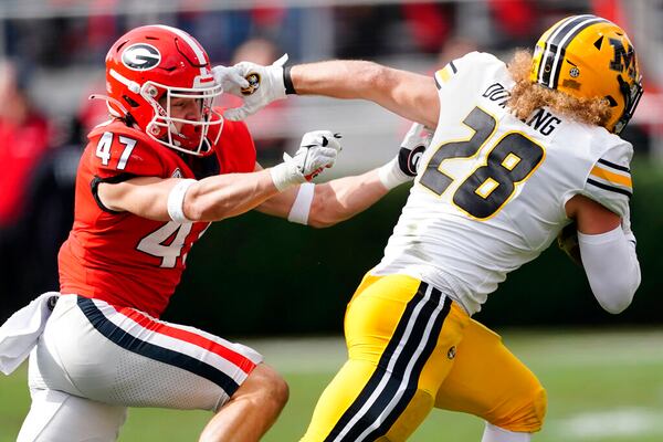 Missouri running back Dawson Downing (28) fends off Georgia defensive back Dan Jackson in the second half of a game last season in Athens. (AP Photo/John Bazemore)