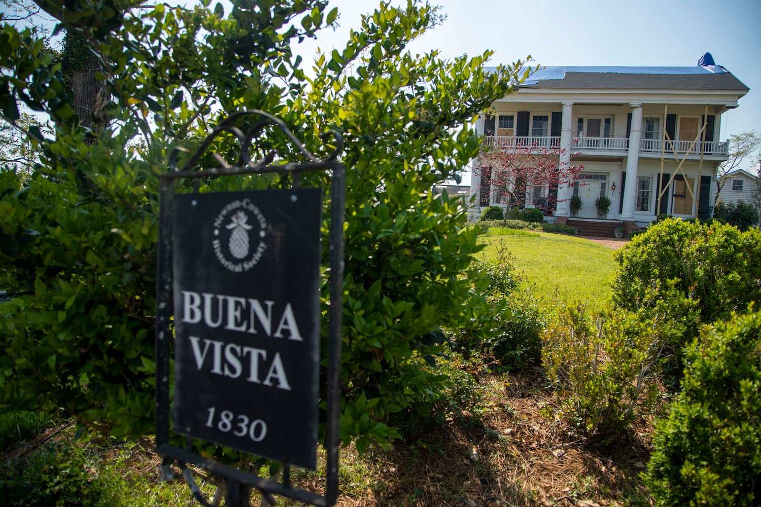 The antebellum Buena Vista home in Newnan suffered tornado damage to its roof and Ionic columns. (Alyssa Pointer / Alyssa.Pointer@ajc.com)