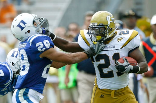 Tech's Jonathan Dwyer stiff-arms Duke's Adrian Aye-Darko on his way for some extra yardage. Dwyer ran for a career-best 159 yards on 23 carries. His longest run of the day was for 36 yards.