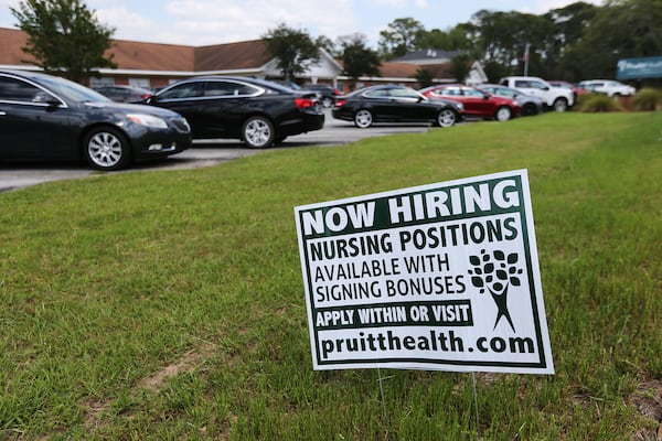 A "now hiring" sign sat in front of PruittHealth-Palmyra nursing home in 2020, in Albany. Nearly two years later, Neil Pruitt, CEO of PruittHealth, says, “In my entire career, I’ve never seen the staffing crisis as acute as it is today.” (Curtis Compton / ccompton@ajc.com)