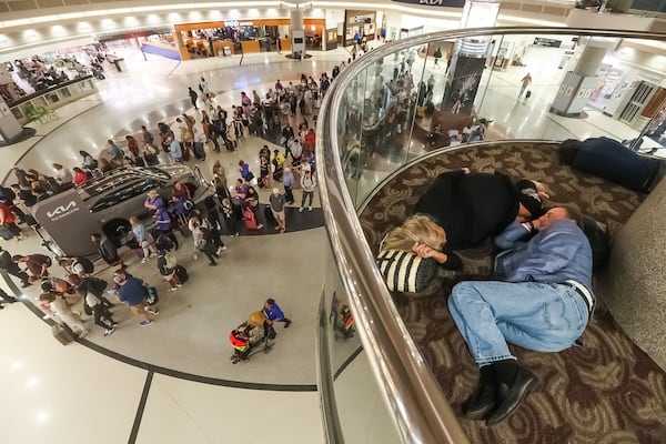 Passengers slept at Hartsfield-Jackson early in the morning of Monday, July 22, 2024, amid a Delta Air Lines operational meltdown. (John Spink / John.Spink@ajc.com)