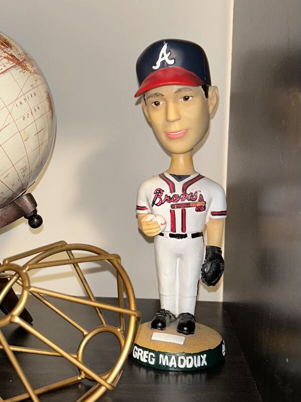 A Greg Maddux bobblehead sits on a shelf  in Utah as one of the lone mementos of Gavin McElroy after most of his belongings were stolen.