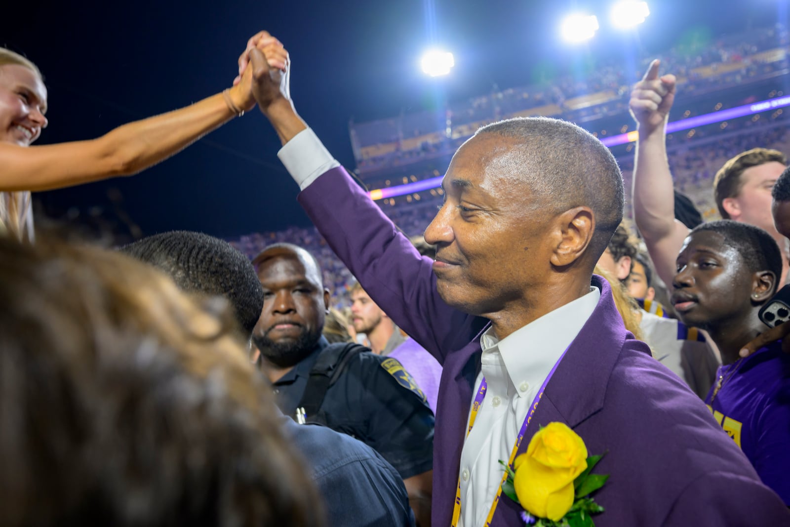 LSU president William F. Tate IV celebrates with LSU fans after they rushed the field after the team's overtime victory over Mississippi during an NCAA college football game in Baton Rouge, La., Saturday, Oct. 12, 2024. (AP Photo/Matthew Hinton)