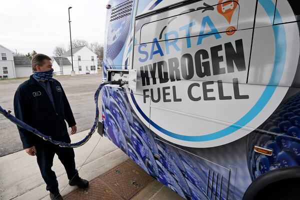 Kevin Baker, a maintenance technician, refuels a hydrogen fuel cell bus, Tuesday, March 16, 2021, in Canton, Ohio. Hydrogen, the most abundant element in the universe, is increasingly viewed as a vital answer to troubling questions about how to slow the catastrophic effects of climate change attributed to the planet's 1.2 billion cars and trucks, nearly all of which burn gasoline and diesel. (AP Photo/Tony Dejak)