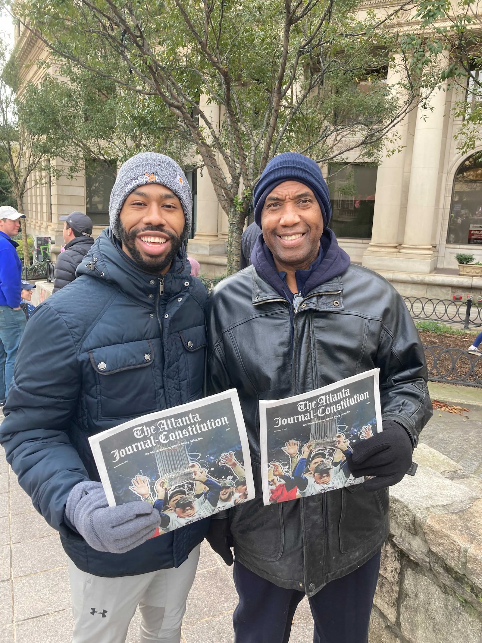 Britton Wright, left, poses with his father Billy, a lifelong Atlantan, at the Braves World Series parade on Nov. 5, 2021. The two also attended the Braves' last championship parade in 1995. J.D. Capelouto/AJC