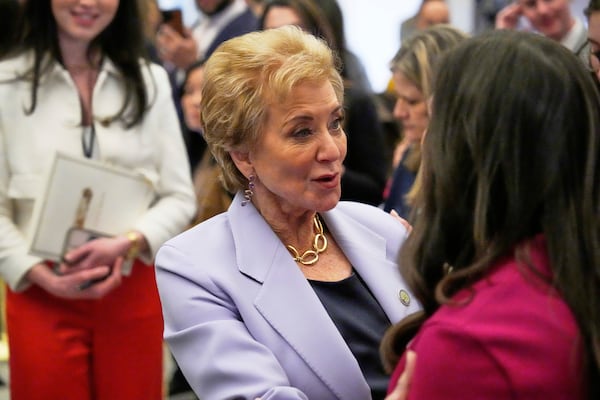 Education Secretary Linda McMahon, left, greets Sen. Katie Britt, R-Ala., before President Donald Trump addresses a joint session of Congress at the Capitol in Washington, Tuesday, March 4, 2025. (AP Photo/Ben Curtis)