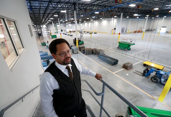 Khalfani Stephens, executive director of the Development Authority of Clayton County, looks over the interior of the massive new LTI Inc., food service equipment manufacturer building in Jonesboro. The expansion of the longtime Clayton company is a win for the county’s economic development team. Curtis Compton/ccompton@ajc.com