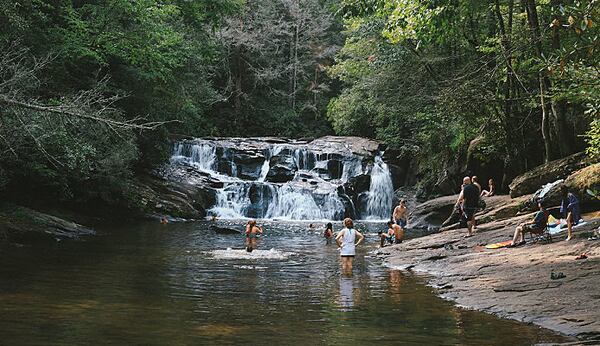 Swim beneath a waterfall