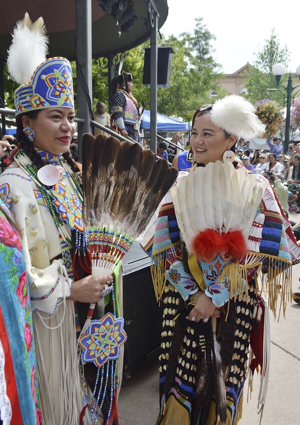 This Aug. 23, 2015, photo courtesy Santa Fe Indian Market shows two participants in the Female Adult category of the 2015 Santa Fe Indian Market Fashion Challenge of the Native American Clothing Contest at the Santa Fe Indian Market in Santa Fe., N.M. For nearly a century, American Indian jewelers, potters and other artists have been gathering in the heart of northern New Mexico to show off their creations at one of the nation's most prestigious art markets. The annual Santa Fe Indian Market begins Saturday, Aug. 19, 2017. (Phil Karshis/Courtesy of SWAIA/Santa Fe Indian Market via AP)