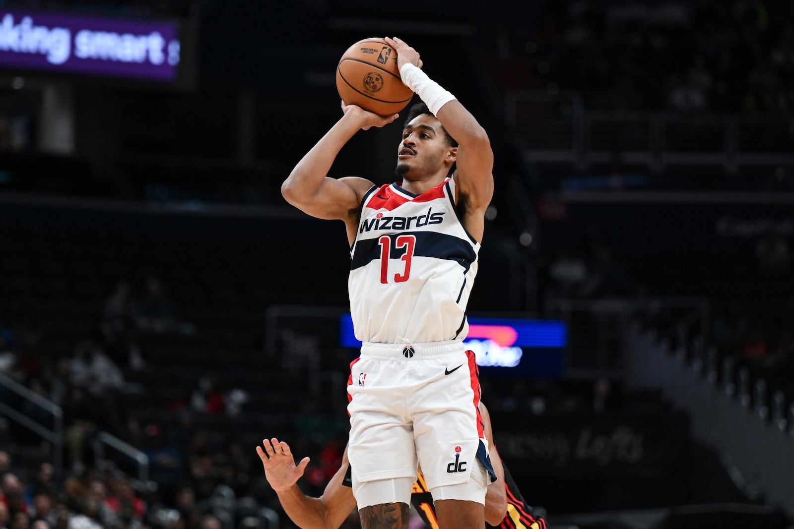 Washington Wizards guard Jordan Poole (13) shoots a 3-point basket during the first half of an NBA basketball game against the Atlanta Hawks, Wednesday, Oct. 30, 2024, in Washington. (AP Photo/Terrance Williams)