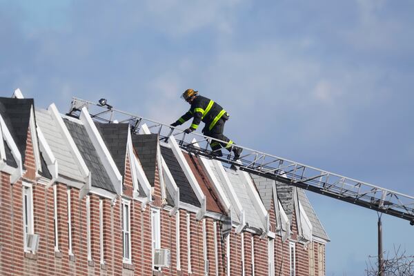 Investigators work the scene after a small plane crashed in Philadelphia, Saturday, Feb. 1, 2025. (AP Photo/Matt Rourke)