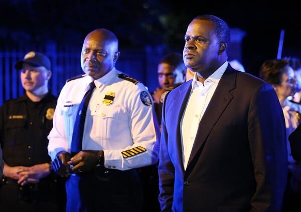 Mayor Kasim Reed and Chief of Police George Turner stand in the street outside the Governor's mansion meeting with protesters during a fifth night of Black Lives Matter demonstrations on Monday, July 11, 2016, in Atlanta. Curtis Compton /ccompton@ajc.com